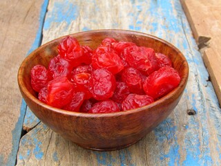 Dried cherry in a bowl on wooden background