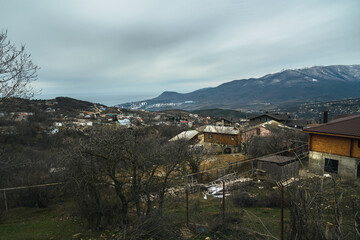 Fototapeta na wymiar View of the village Luchistoe from the slope of Demerdzhi mounting in spring. Crimea