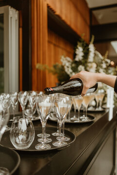 Wedding and event catering pouring wine in glasses in restaurant