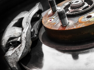 Close up of dirty Disc brake of the vehicle for repair, in process of new tire replacement. Car...