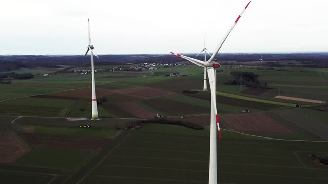 Critical Energy Production: Rotating Windmills on a Field in Sauerland, Germany, Aerial Panning Sho