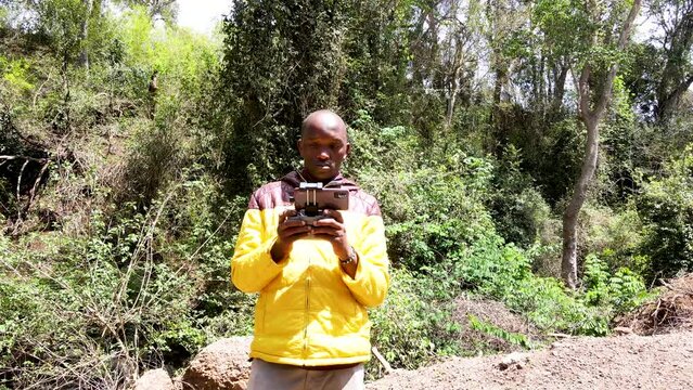 Airplane industrial UAV innovative drone pilot taking drone photography  operating security drone in the forest of Kenya