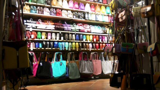 Store in Rome, Italy selling purses and handbags with video establishing shot at night.