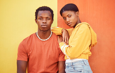 Fashion portrait of African couple, people or friends relax with designer brand clothes, casual style and luxury apparel. Urban gen z aesthetic, black woman and man on orange yellow background wall - obrazy, fototapety, plakaty