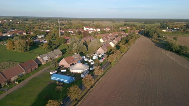Kremmen country road, barns and circus tent. 
Stunning aerial view flight wide orbit overview drone
brandenburg golden houre 2022. 4k marnitz Cinematic