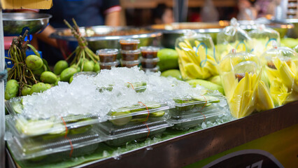 Thai street food in temple fair, and night local markets in Bangkok. Asian Retail shops. Travel in Thailand.