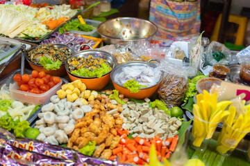 Thai street food in temple fair, and night local markets in Bangkok. Asian Retail shops. Travel in Thailand.