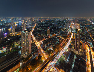 Fototapeta na wymiar Aerial view of Bangkok Downtown Skyline, Thailand. Financial district and business centers in smart urban city in Asia. Skyscraper and high-rise buildings at night.