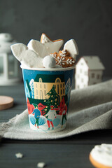 Paper cup with marshmallows and New Year's Christmas cookies