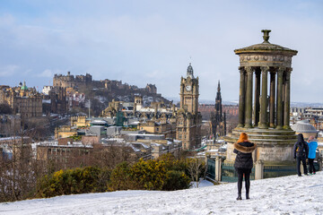 Calton Hill , Dugald Stewart Monument and Cityscape view of Edinburgh old town during winter snow at Edinburgh , Scotland : 28 February 2018