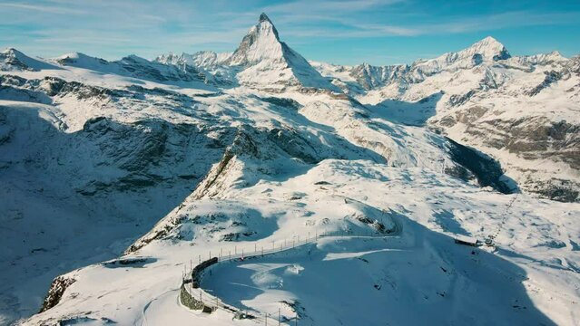 Aerial view, Matterhorn mountain and gornergrat train in sunny winter, Swiss Alps, Zermatt, Switzerland. Tourist journey trip concept