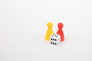 pawns board game pieces and six sided dice on white background