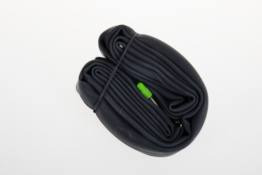 New Bicycle Inner Tube Black And Green Cap On White Background