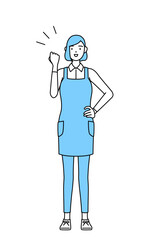 ガッツポーズをするエプロンを着た女性