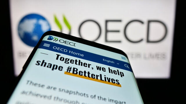 Stuttgart, Germany - 12-23-2022: Mobile phone with website of intergovernmental organisation OECD on screen in front of logo. Focus on top-left of phone display.