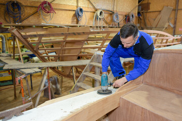 a carpenter using circular sander