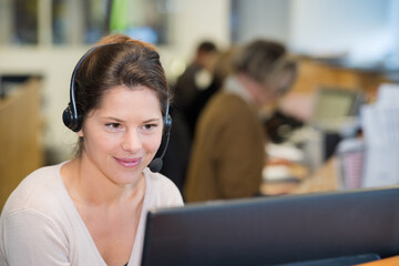 smiling female helpline operator with headphones