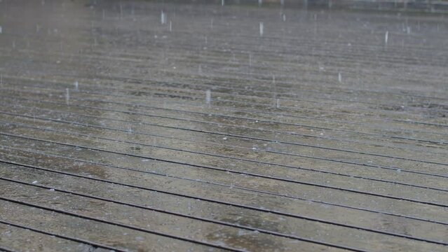 Wet wooden slippery terrace from first snow.