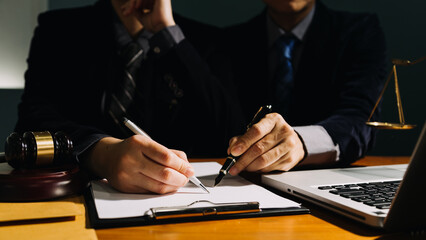 Business and lawyers discussing contract papers with brass scale on desk in office. Law, legal...