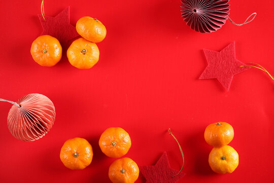 symbol chinese new year red background, tangerines © Olga Kriger