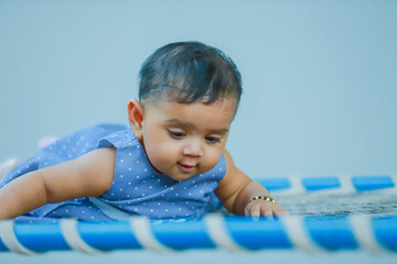 indian little baby seating on bed