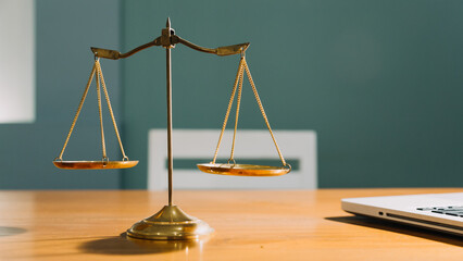 Business and lawyers discussing contract papers with brass scale on desk in office. Law, legal services, advice, justice and law concept picture with film grain effect