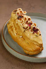 Eclair served with fried  hazelnuts