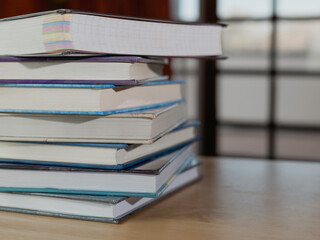 Stack or plie of vintage old books on wooden table. Learning, education and study concept. one of them open with copy space.