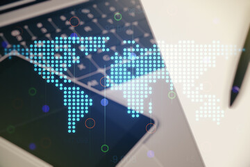 Double exposure of abstract digital world map on laptop background, research and strategy concept