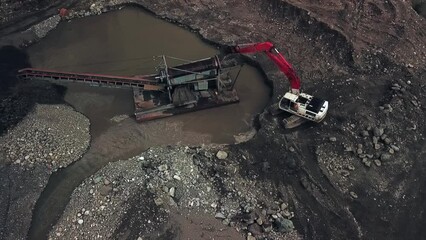 Aerial View of Excavator Feeding Pay Dirt into Sluice Box Trommel on Placer Mining Site in the Breathtaking Yukon Territory, Canada
