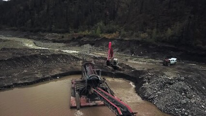 Get a Unique Perspective on Placer Mining in the Yukon - Aerial View of Excavator Feeding Pay Dirt into Sluice Box Trommel