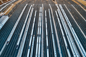Aerial shots of multiple high-speed trains parked on railway tracks