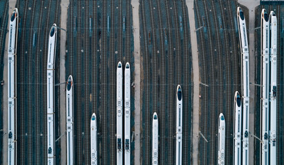 Obraz premium Aerial shots of multiple high-speed trains parked on railway tracks