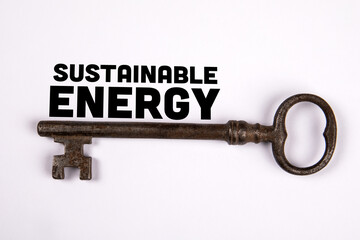 Sustainable Energy Concept. Text and old key on white background