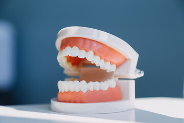 Stomatology concept, partial portrait of girl with strong white teeth looking at camera and smiling, fingers near face. Closeup of young woman at dentist's, studio, indoors