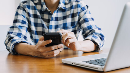 Hands holding credit card and using laptop. Online shopping