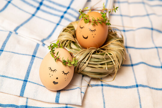 Easter eggs with cute face in green plant wreath. Sleepy easter egg - Home crafts happy haster concept.