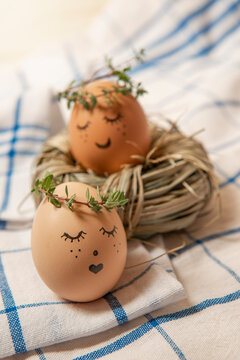 Easter eggs with cute face in green plant wreath. Sleepy easter egg - Home crafts happy haster concept.