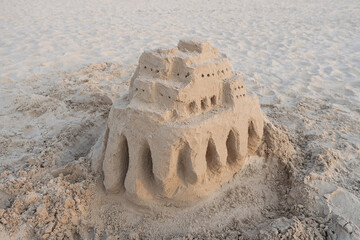 Sand castle on sea shore, sand sculpture on the beach