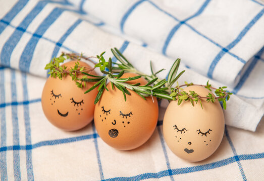 Easter eggs with cute face in green plant wreath. Sleepy easter egg - Home crafts happy haster concept.