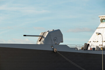 A large cannon on board an army warship. A gun turret on a battleship