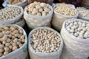 Big bags with kurut - dried cottage cheese in Osh Bazaar, central market in Bishkek, Kyrgyzstan.  