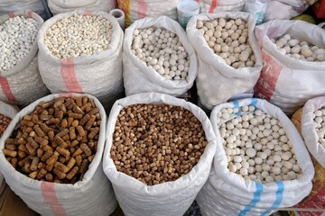 Big bags with kurut - dried cottage cheese in Osh Bazaar, central market in Bishkek, Kyrgyzstan.  