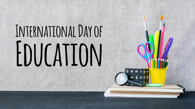International Day of Education concept with color school supplies on desk. International Education Day, 24 January greeting card.