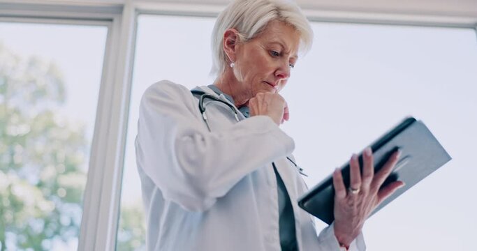 Tablet, thinking or doctor working on research or data analysis for a healthcare solution in a hospital. Innovation, life insurance or senior woman planning or problem solving in medical office room