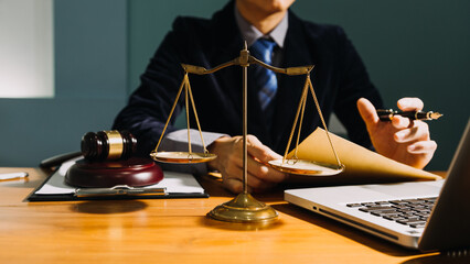 Business and lawyers discussing contract papers with brass scale on desk in office. Law, legal...