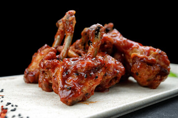 Barbecue chicken legs with spicy sauce and sesame