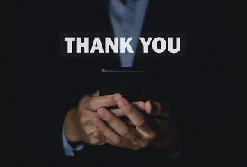 Man touches the smartphone and sends message words to thank you.	
