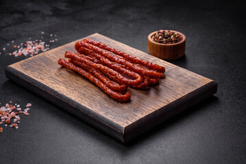 Delicious thin smoked meat sausages with spices and herbs