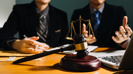 Business and lawyers discussing contract papers with brass scale on desk in office. Law, legal...